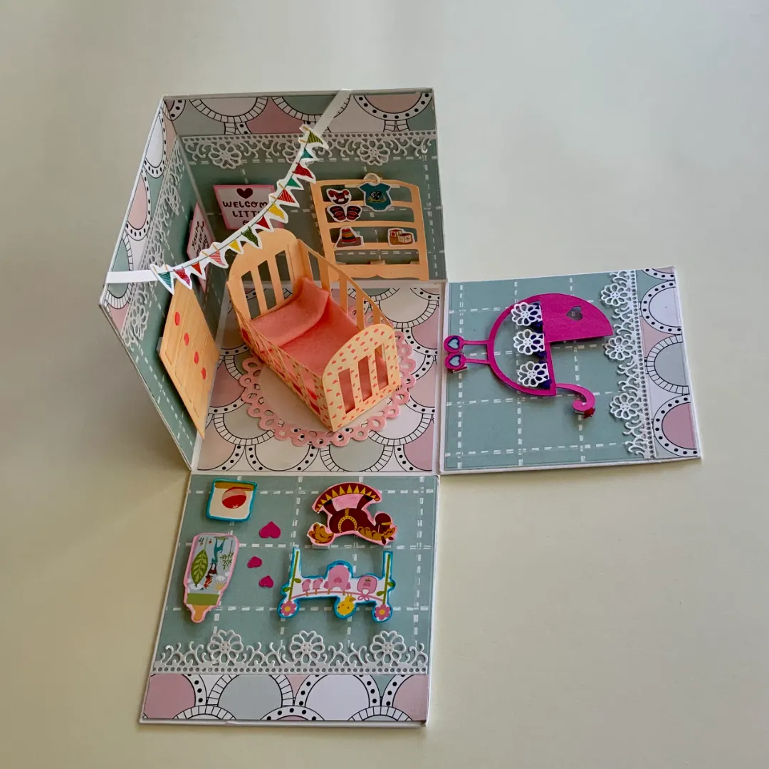 handmade new born card with intricate cuts, layers and embellishments