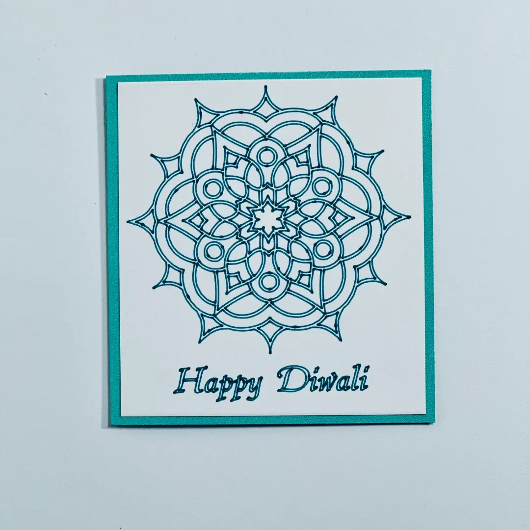 handmade diwali card with a brightly drawn mandala design with glitter effect