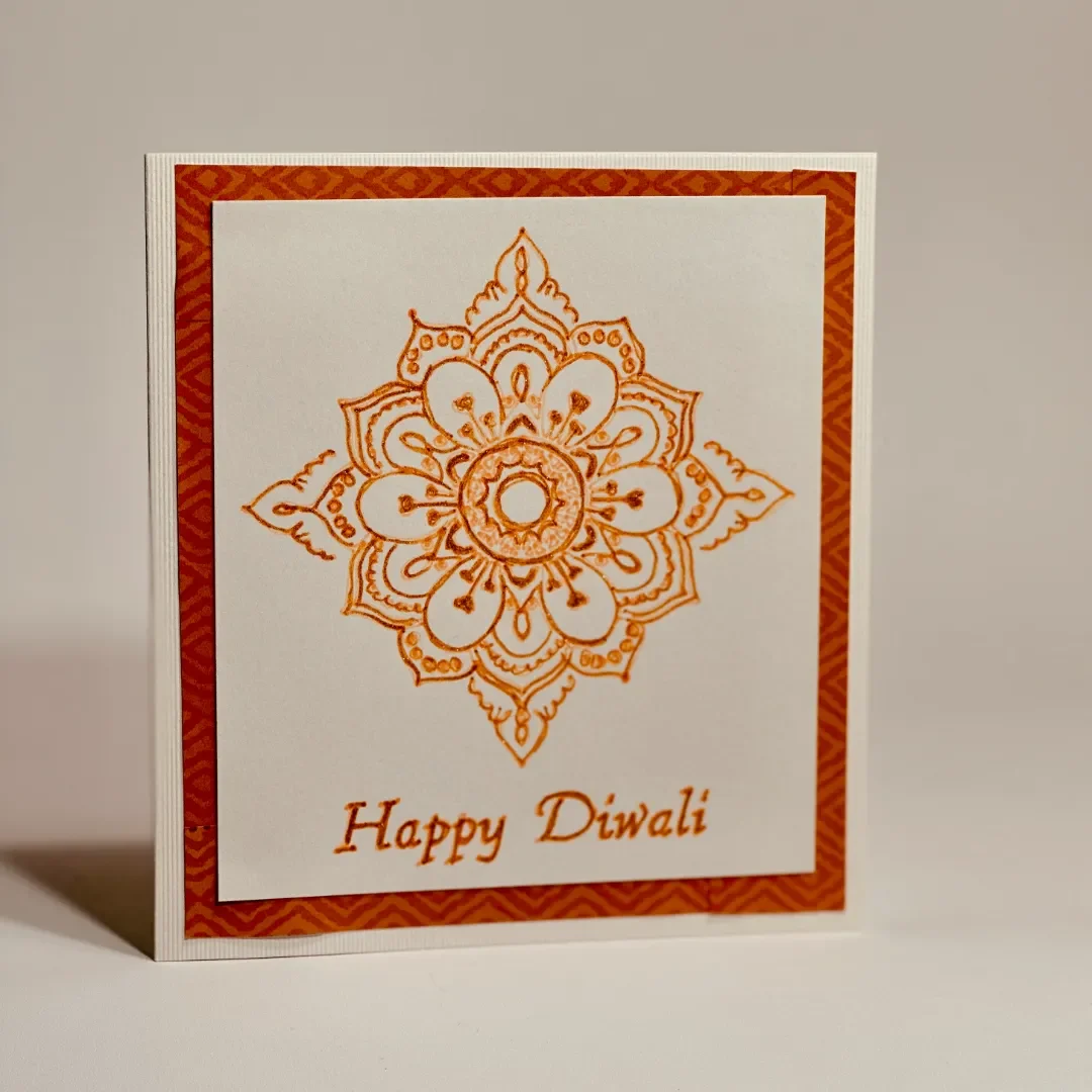 handmade diwali card with a brightly drawn mandala design with glitter effect